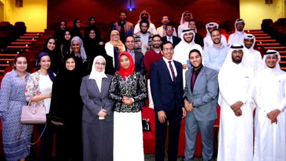 Alaa Afifi (Center)President QU Toastmasters Club seen with her team, organiors and mentors