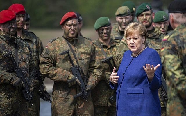 German Chancellor Angela Merkel, right, talks with NAO’s VJTF unit Pic AP